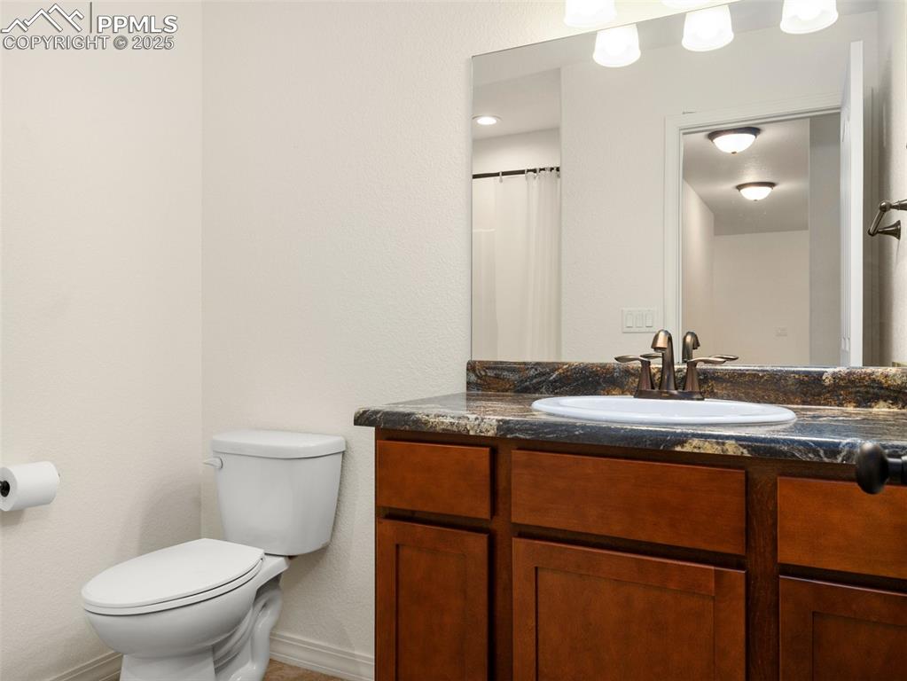 Full bath featuring toilet and vanity