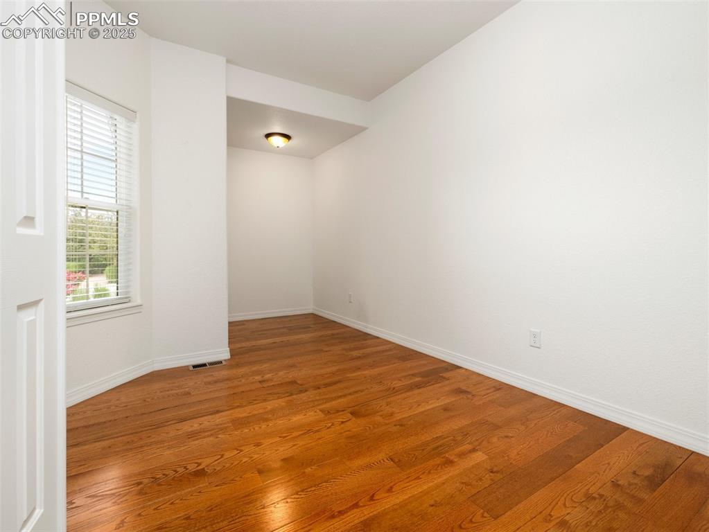 Spare room featuring light wood-style floors and baseboards