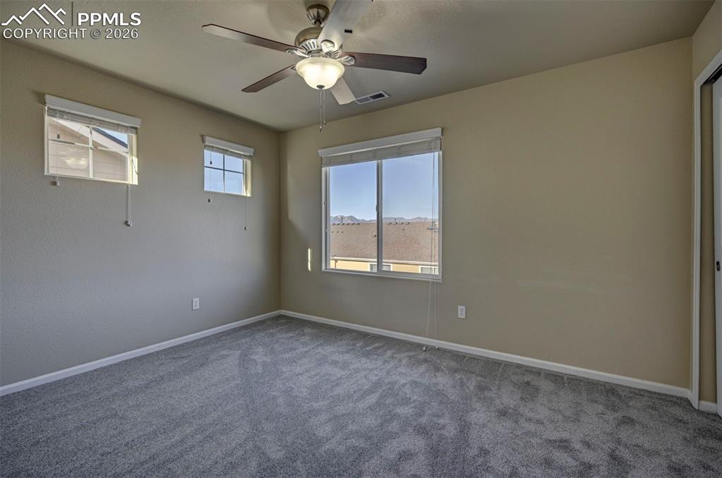 Secondary bedroom with mountain views, and fan.