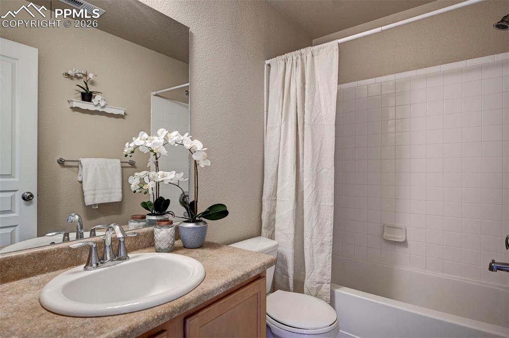 Full bathroom next to the secondary bedroom and laundry area.