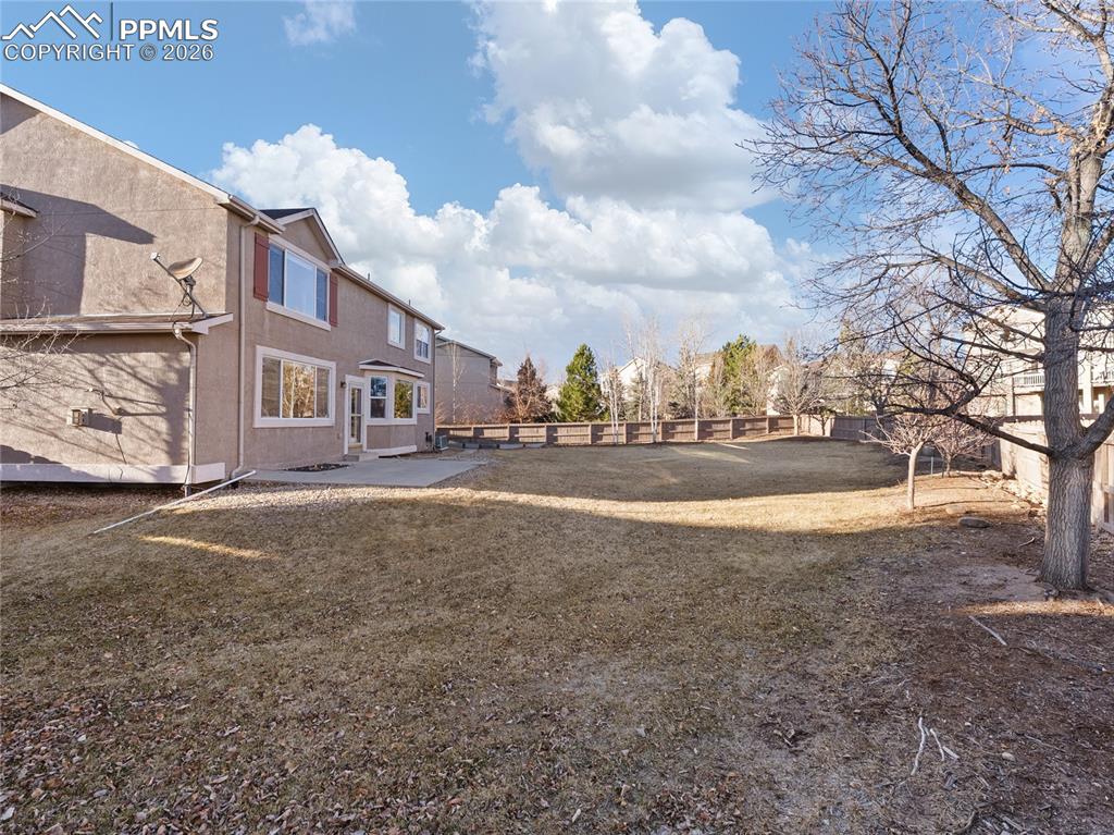 Fenced backyard featuring a patio