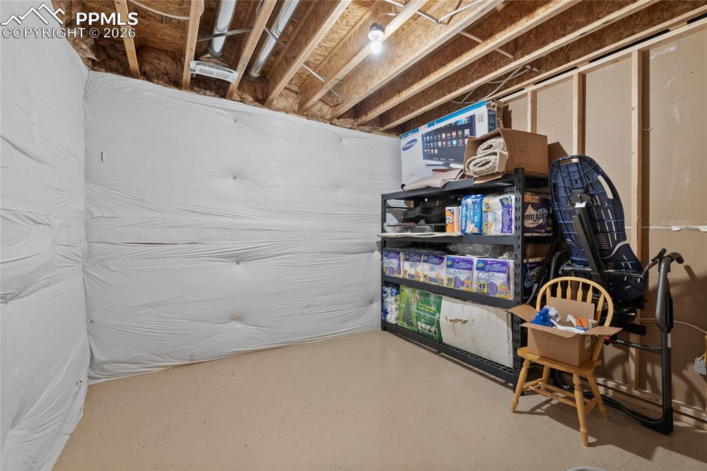 2nd storage room off of lower level bar area with epoxy surface floors and wired for a second electric water heater.