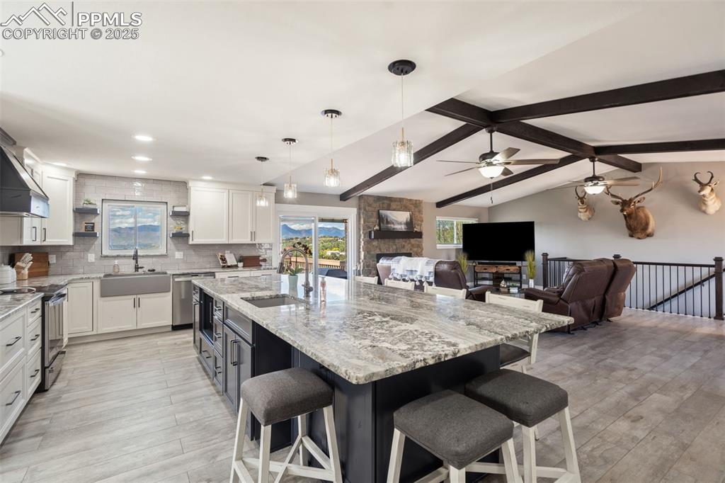 This designer kitchen is stunning with a huge island and breakfast bar, beautiful granite counter tops, a barn sink, all new stainless steel appliances and plenty of natural light to show it off!