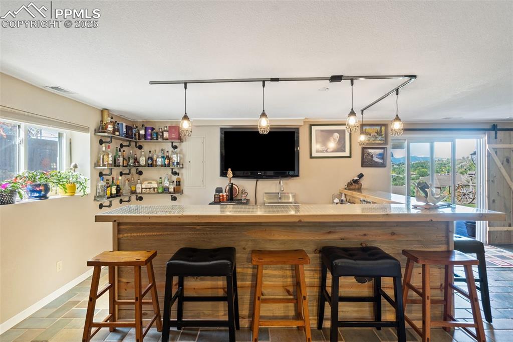 Nicely finished custom wet bar - perfect addition to this space for entertaining and watching the game!
