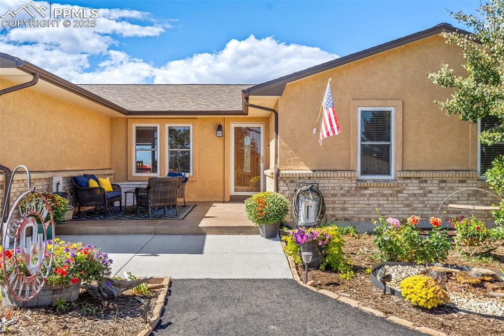 A welcoming front entrance with low-maintenance xeriscape and a stamped concrete front patio area!
