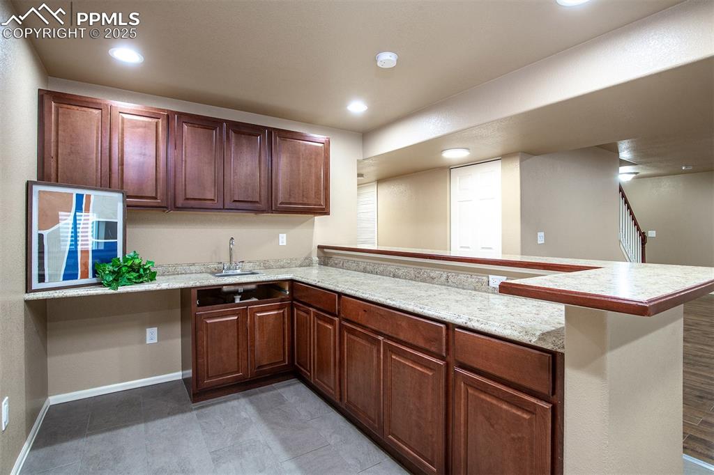 Kitchen with a peninsula and recessed lighting