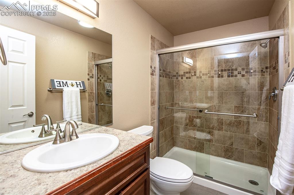 Bathroom with a stall shower and vanity
