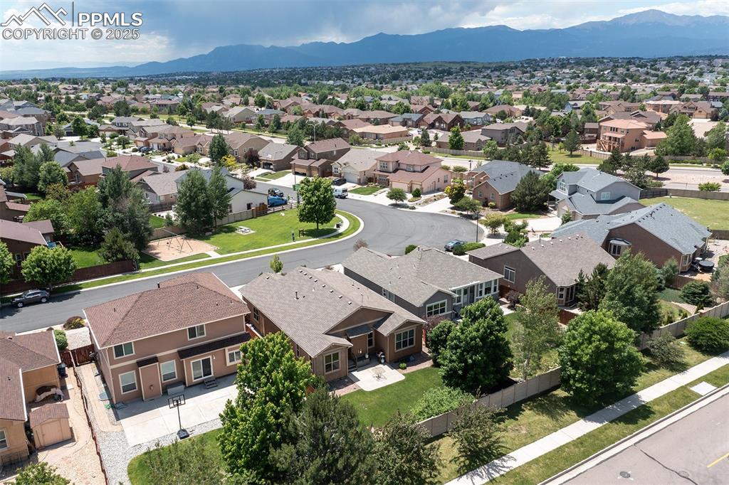 Aerial perspective of suburban area with a mountain backdrop