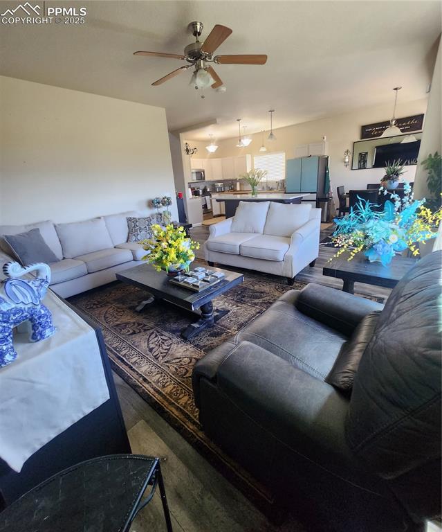 Living room featuring a ceiling fan and wood finished floors
