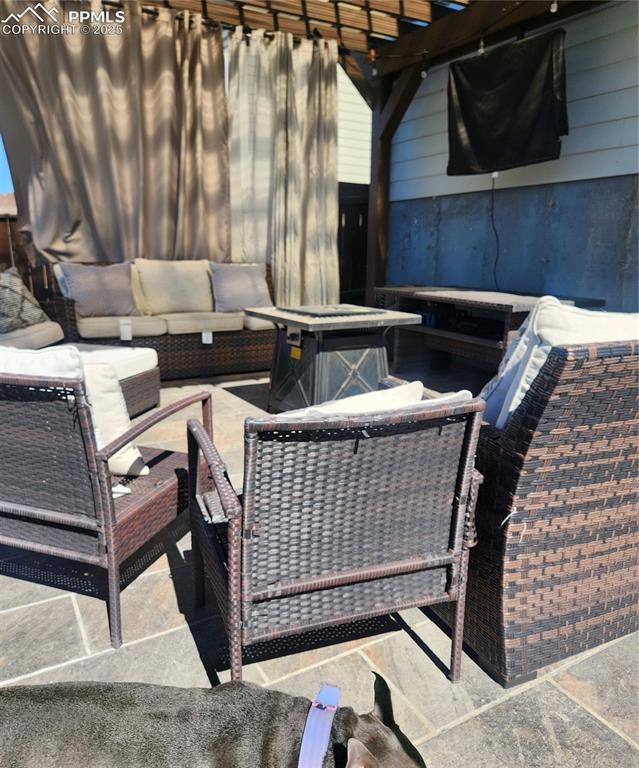View of patio featuring an outdoor hangout area and a pergola