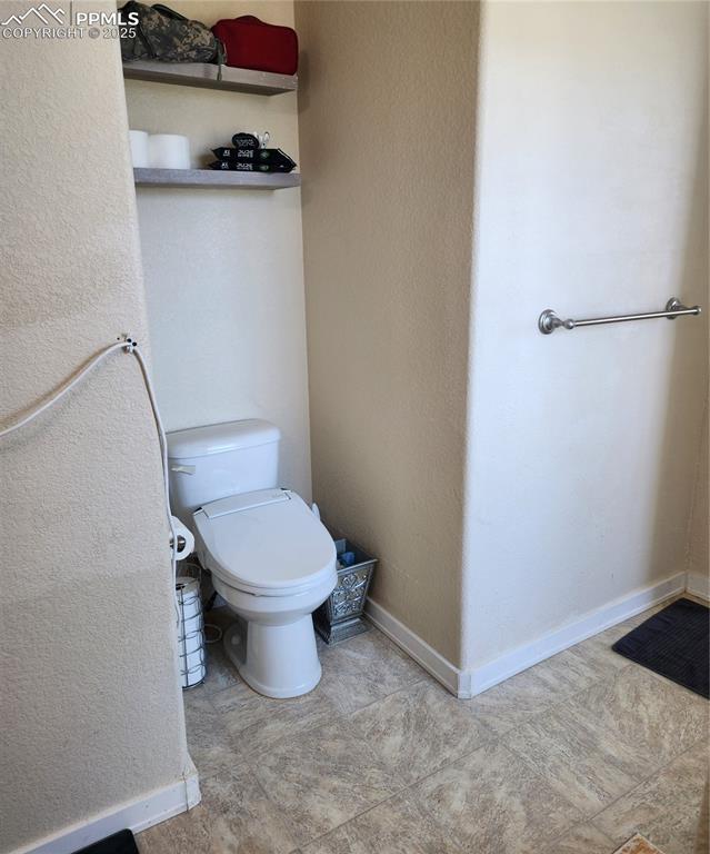 Bathroom featuring a textured wall