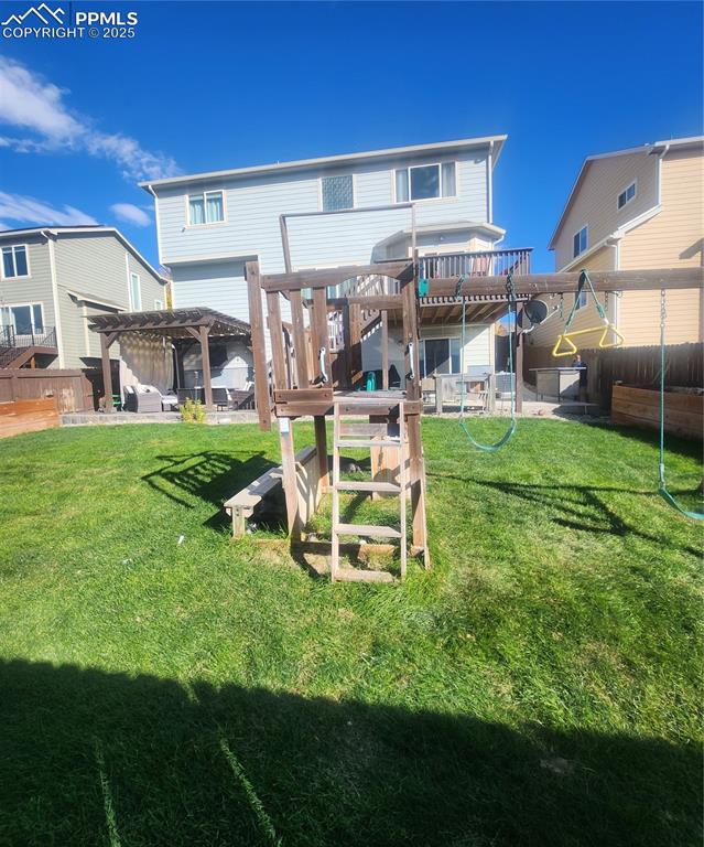 Back of property featuring a pergola, a fenced backyard, a patio, and a playground