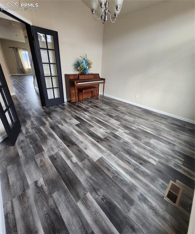 Dining space featuring a chandelier and dark wood-style floors