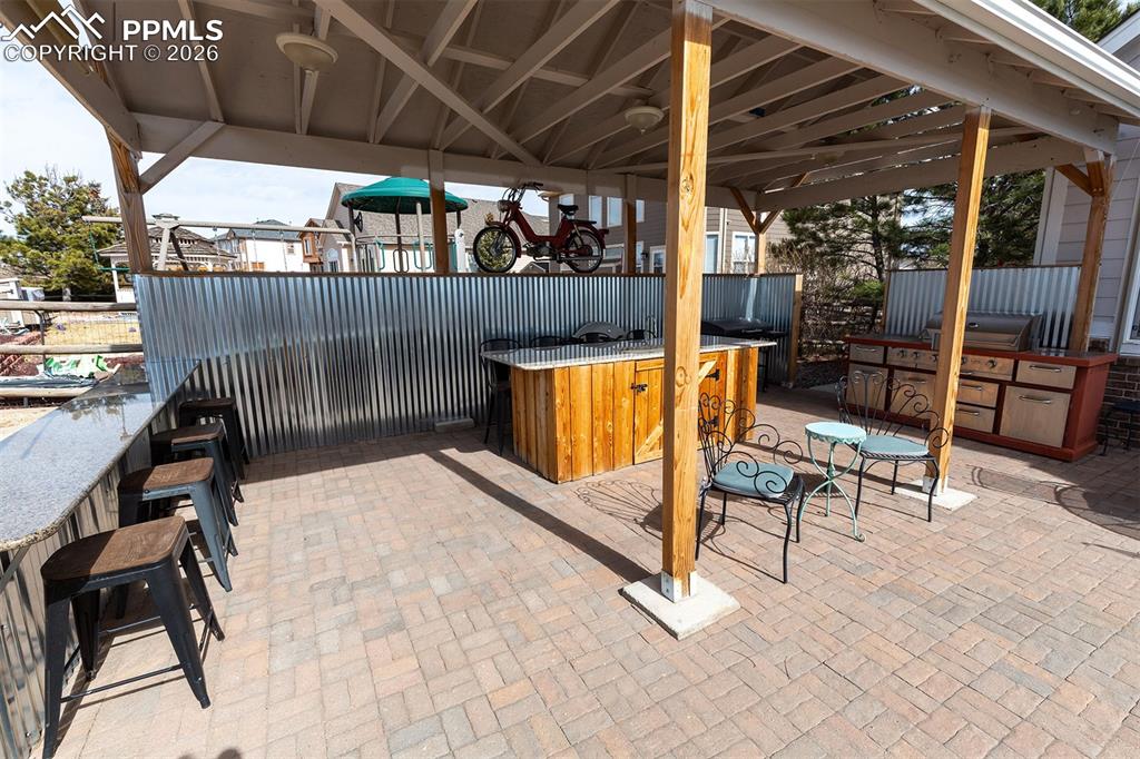 Covered, custom grilling area with killer views of the golf course.