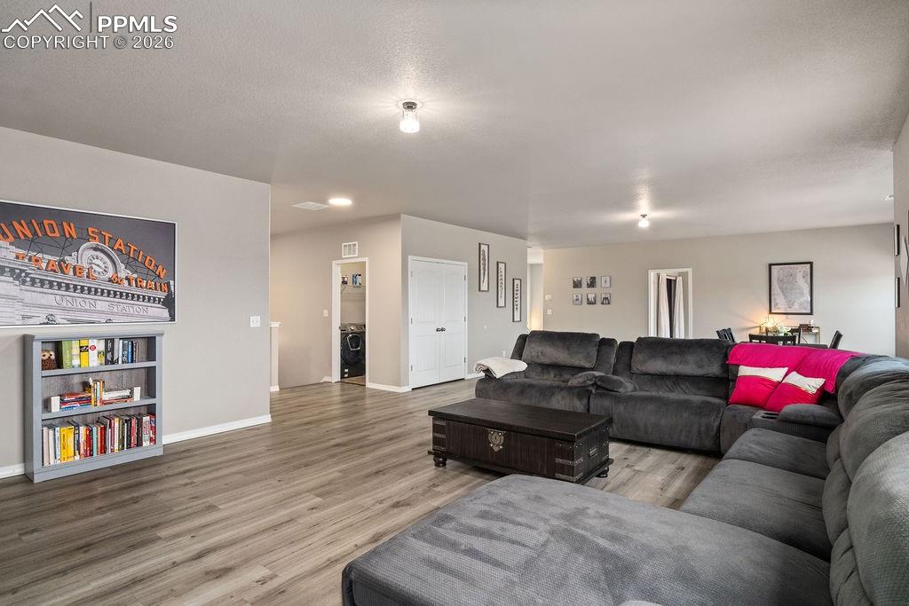 Family room with light wood-style floors and washer / dryer