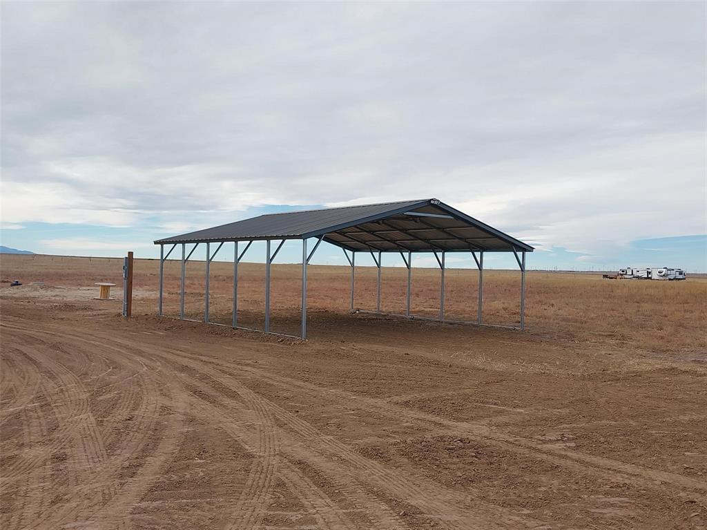 View of property's community with a view of rural / pastoral area, a detached carport, and driveway