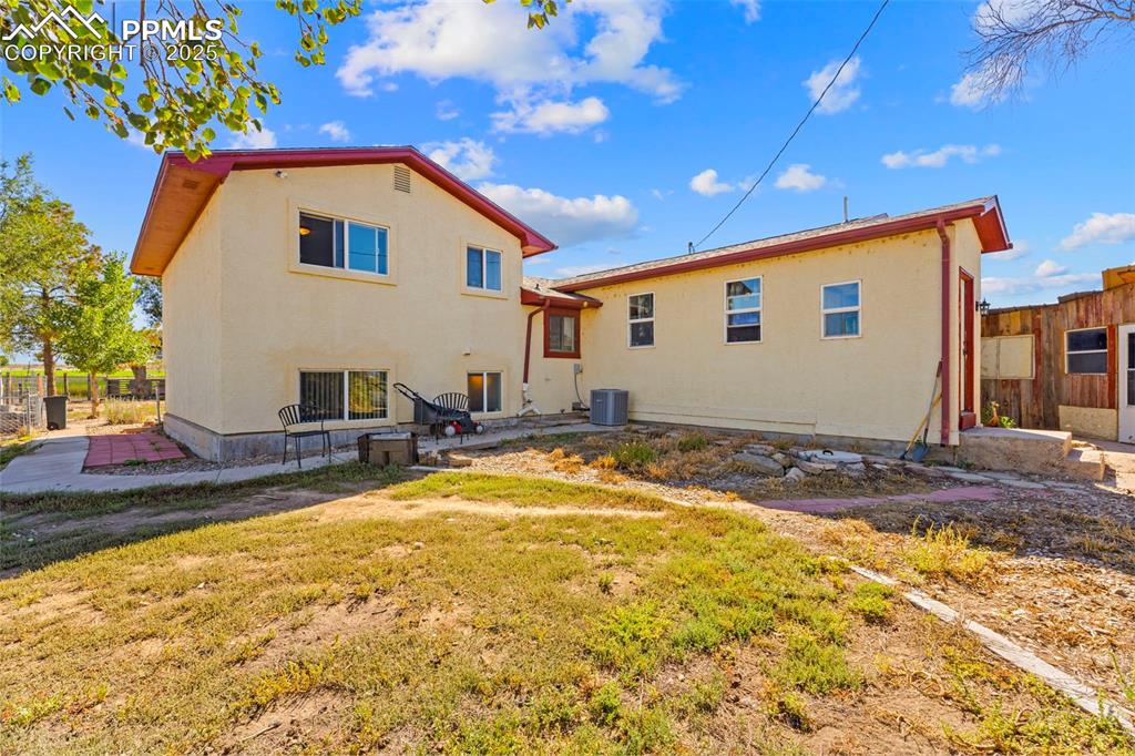 Back of property featuring a patio and stucco siding