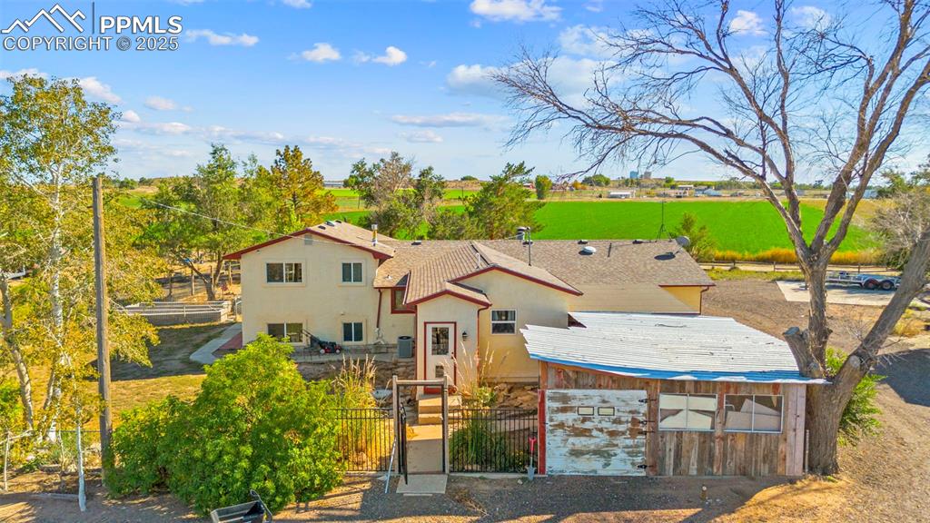 Mediterranean / spanish-style home with a fenced front yard, a gate, and stucco siding