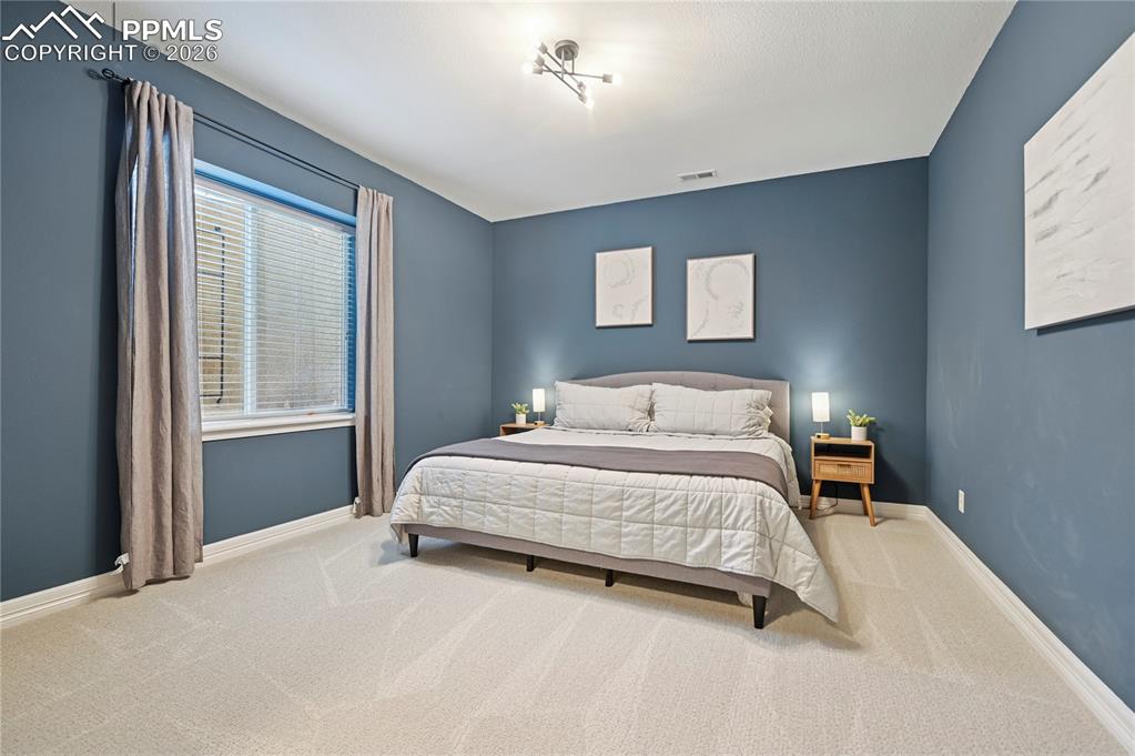 Bedroom featuring baseboards and carpet floors