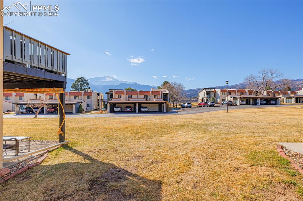 View of green lawn featuring a mountain view and a residential view