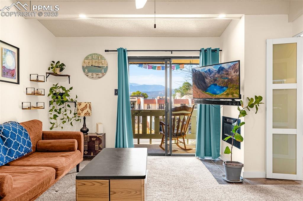 Living room featuring beam ceiling and baseboards