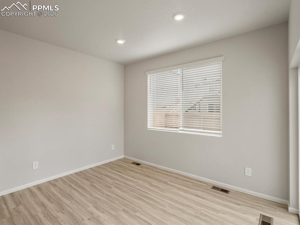 Spare room featuring light wood finished floors and recessed lighting