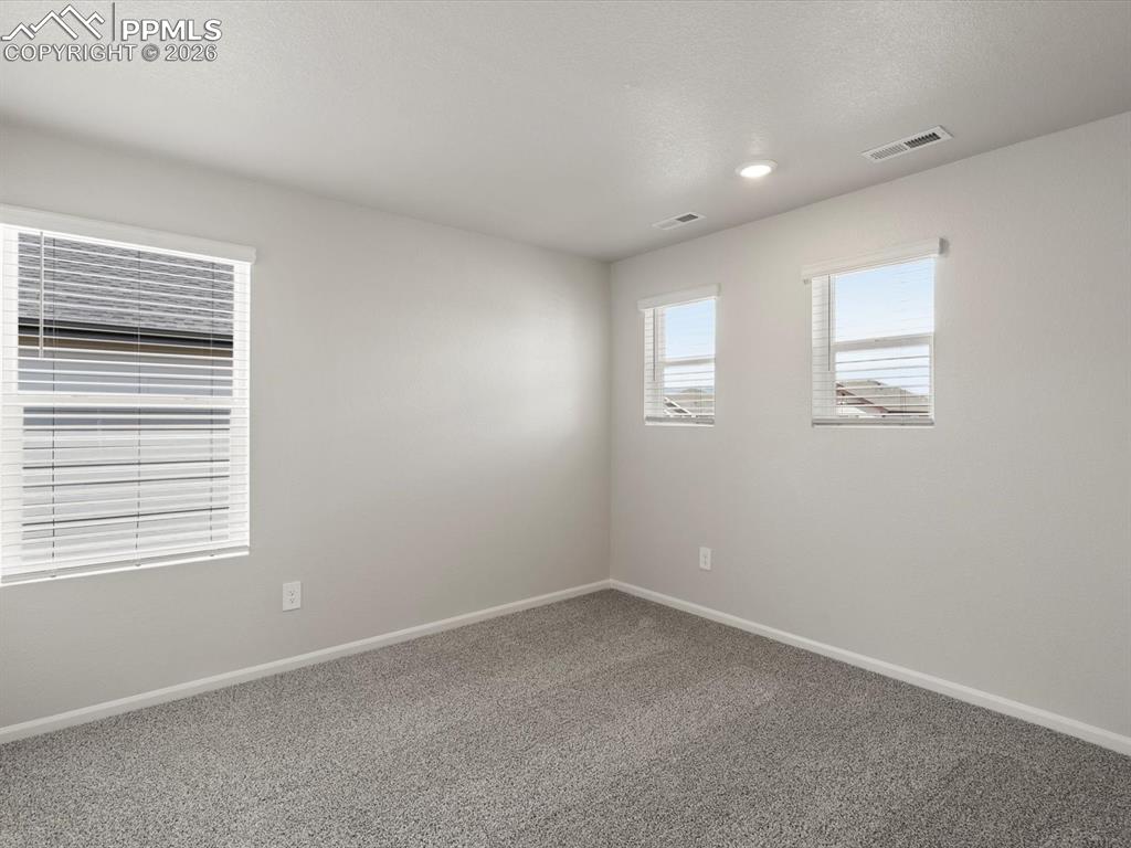 Spare room featuring carpet and recessed lighting