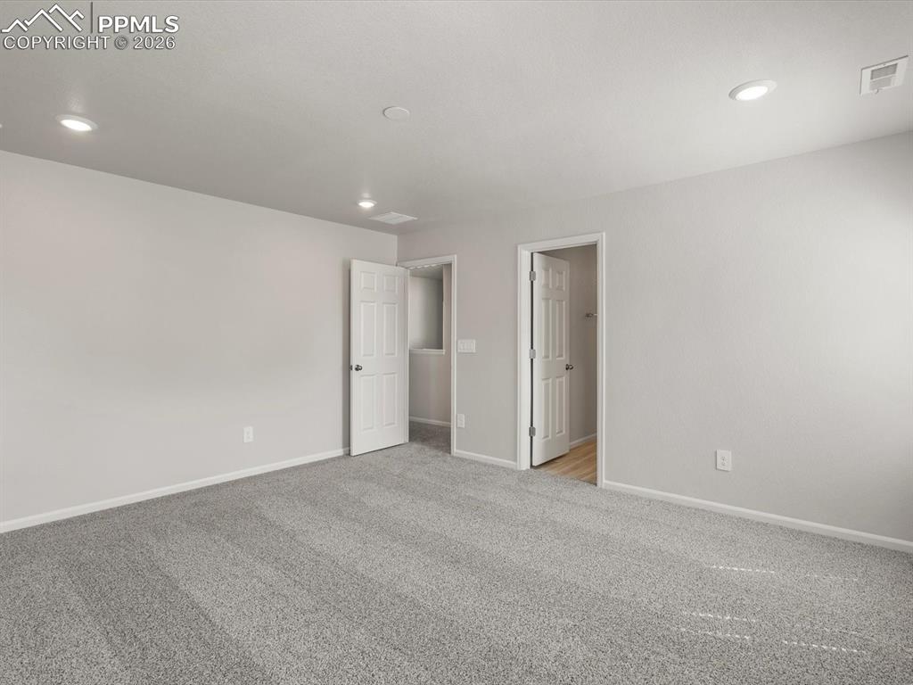 Unfurnished bedroom featuring carpet flooring and recessed lighting