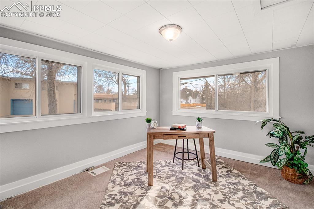 Second main level bedroom with wrap around windows for amazing light