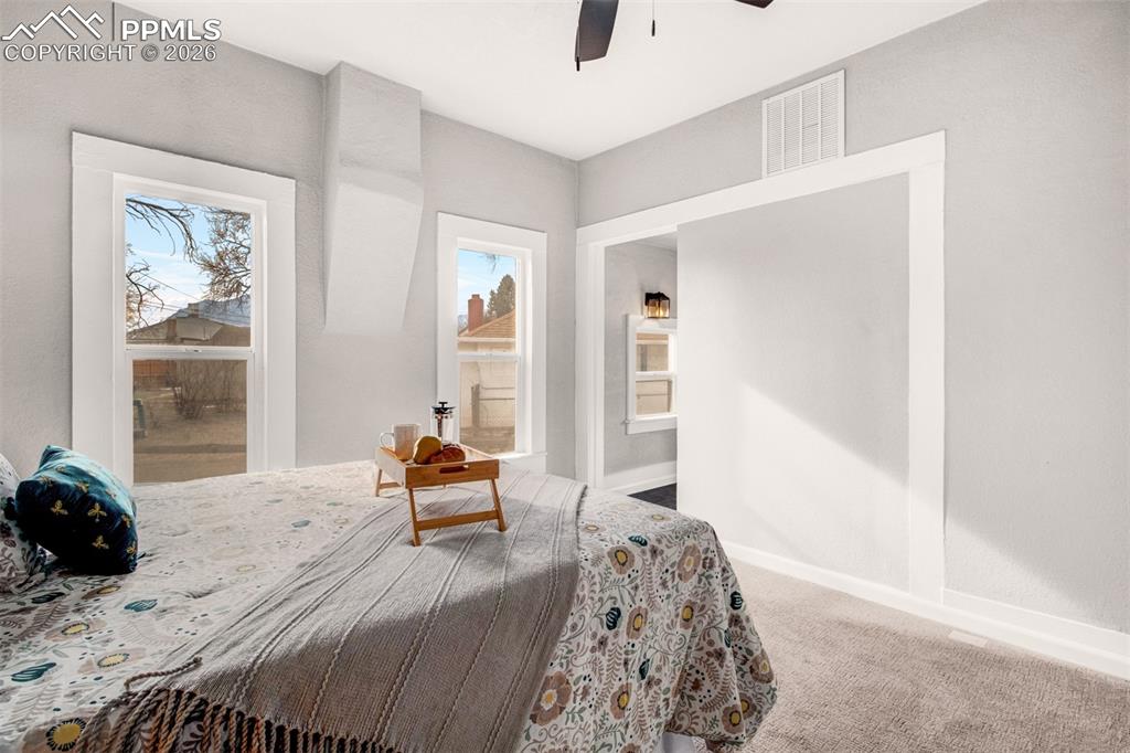 Master bedroom with carpet, ceiling fan and ensuite bath