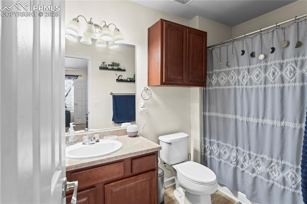 Full bathroom with vanity and curtained shower