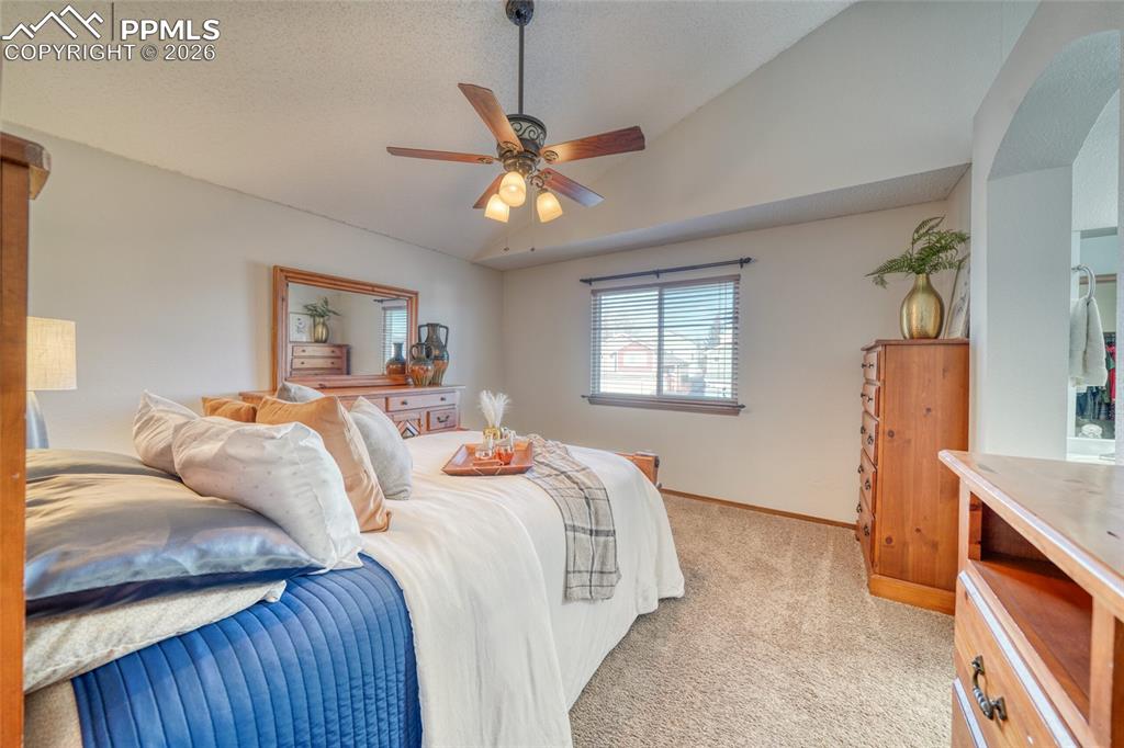 Bedroom featuring light carpet and a ceiling fan