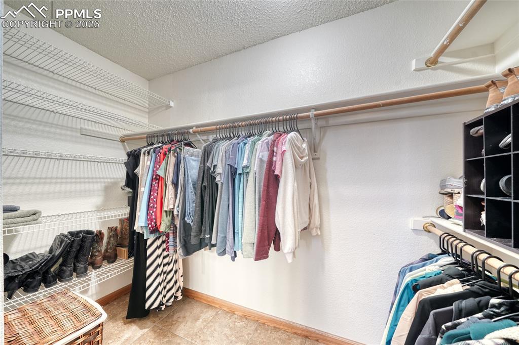 Walk in closet featuring light tile patterned floors