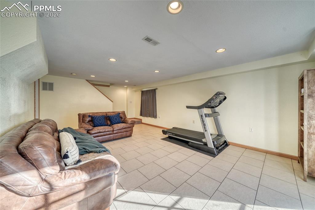Exercise area with recessed lighting and baseboards