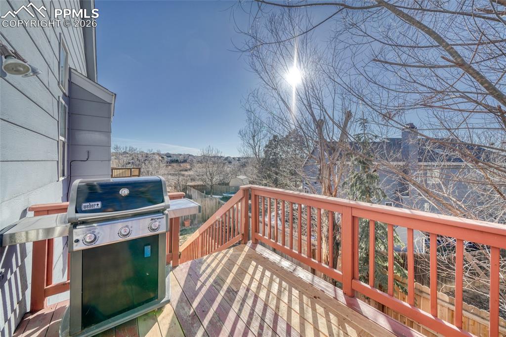Wooden terrace featuring grilling area
