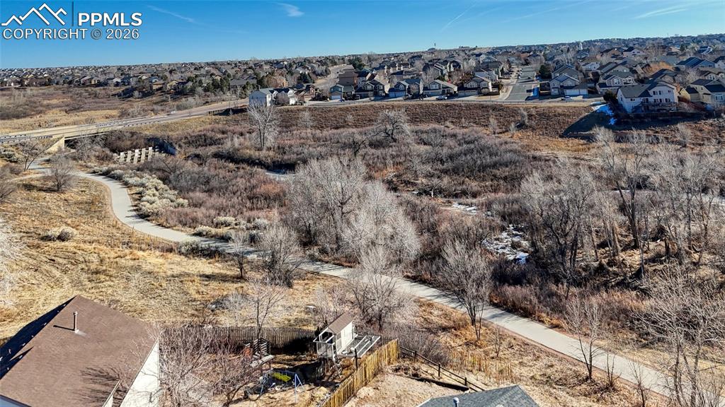 Aerial view of property's location with nearby suburban area