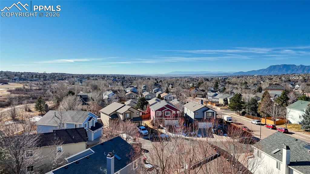 Aerial perspective of suburban area featuring a mountainous background