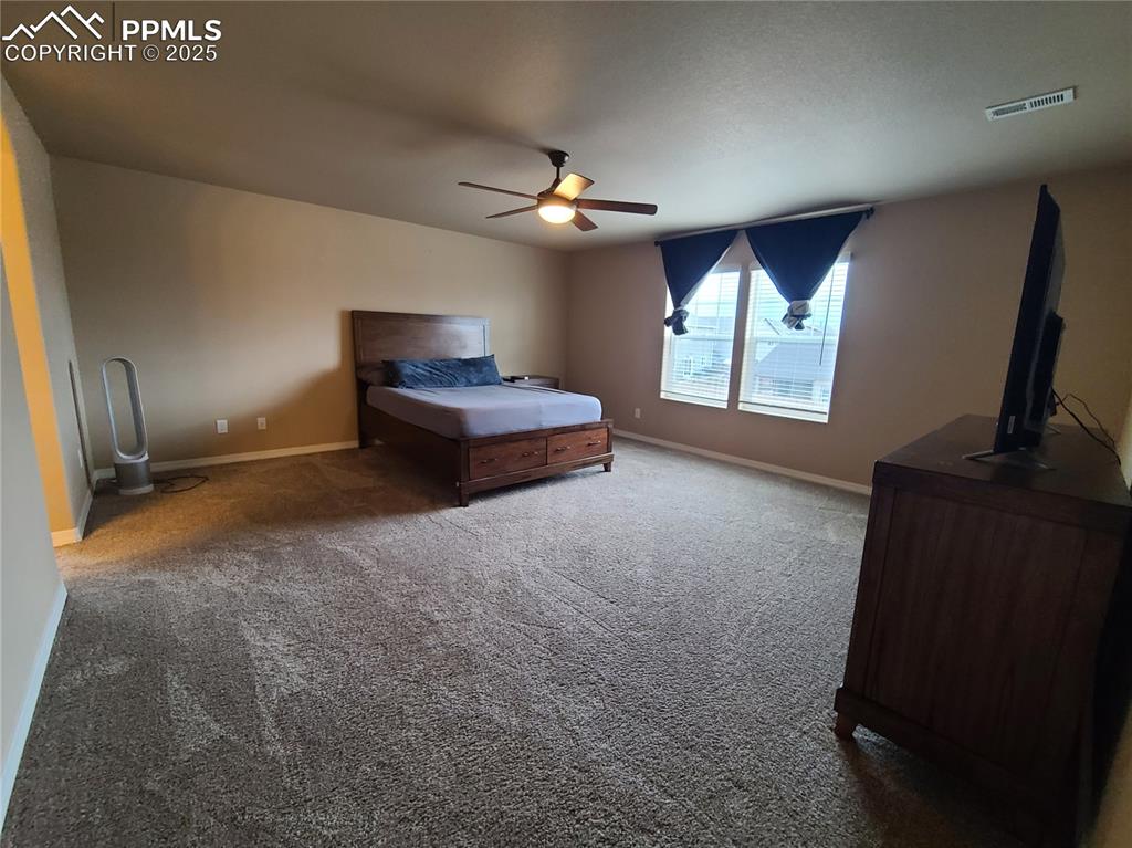Bedroom featuring carpet flooring and ceiling fan