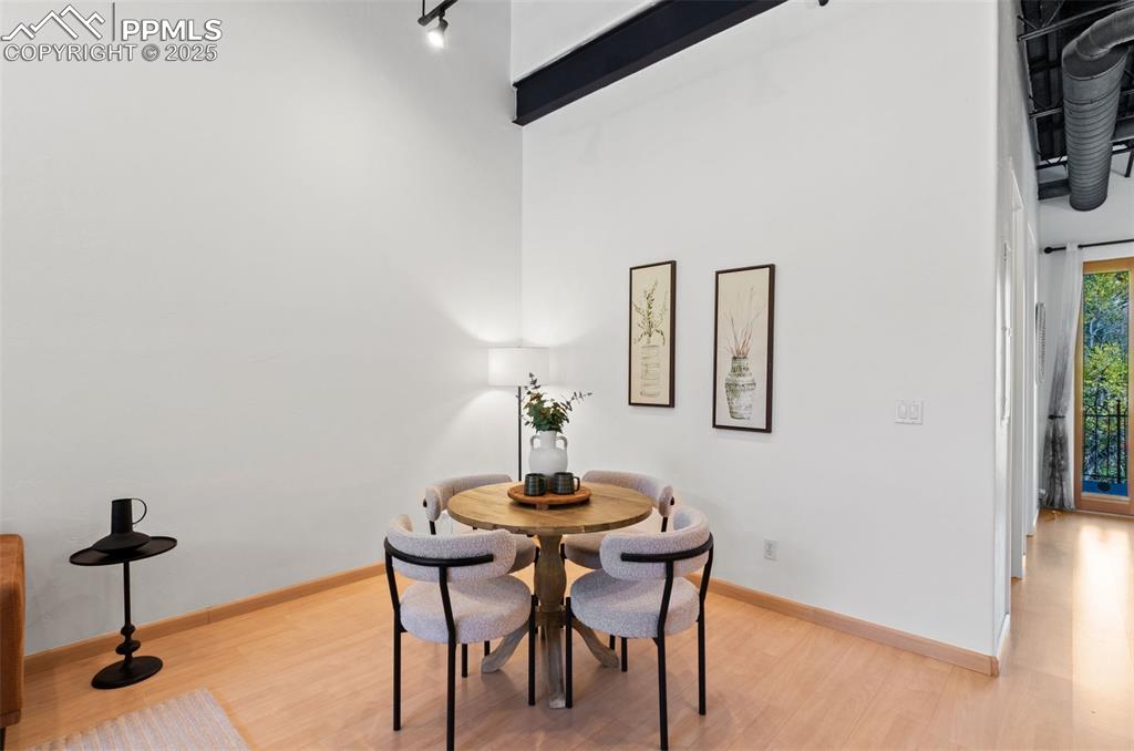 Dining area with light wood-type flooring and baseboards