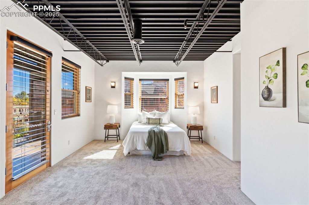 Newly carpeted bedroom featuring walk out covered patio overlooking creek