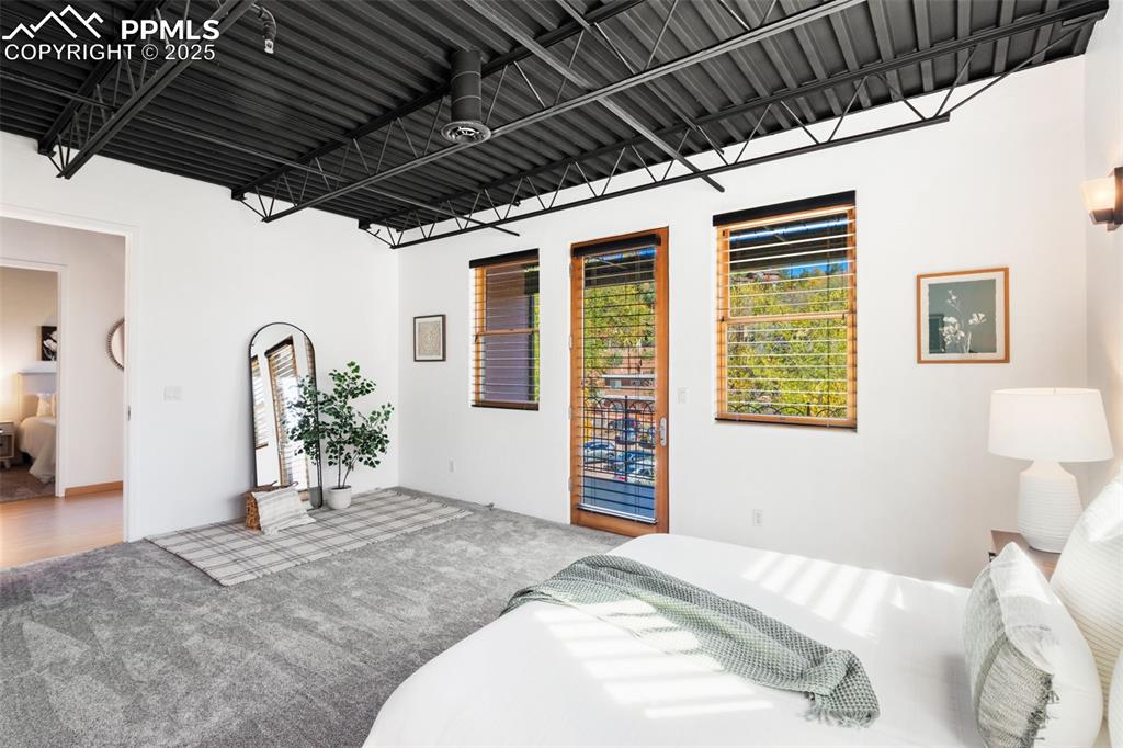 Newly carpeted bedroom featuring walk out covered patio overlooking creek