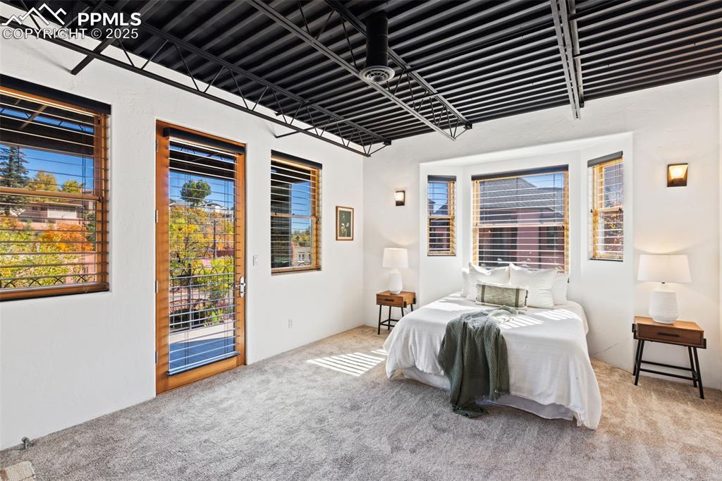Newly carpeted bedroom featuring walk out covered patio overlooking creek