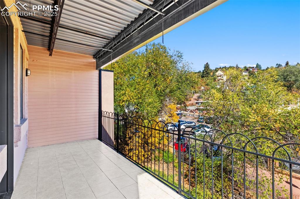 Balcony featuring view of scattered trees