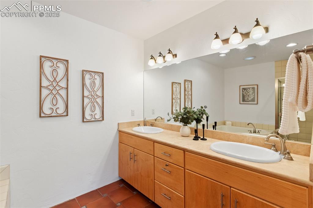 Bathroom with unique stone flooring and double vanity