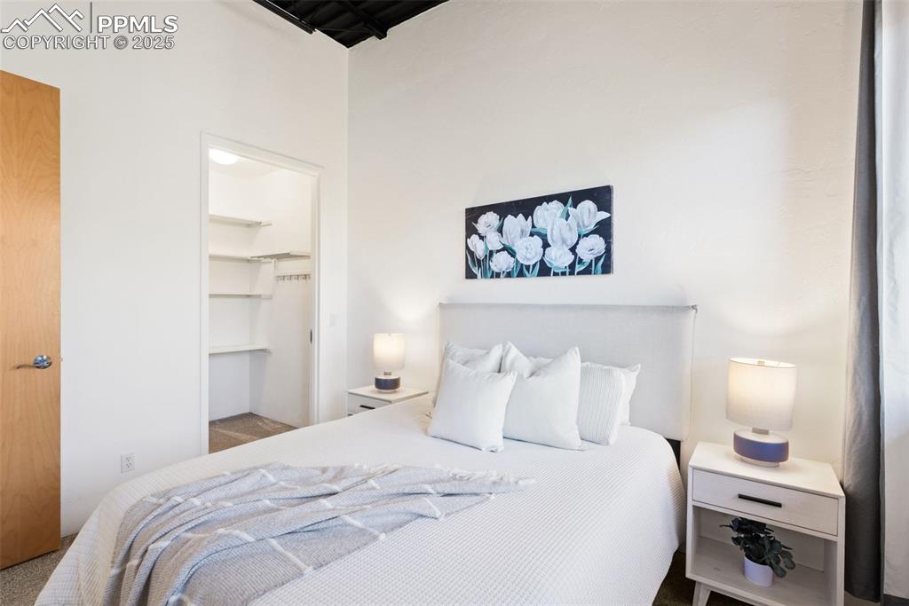 Newly carpeted bedroom featuring a walk in closet