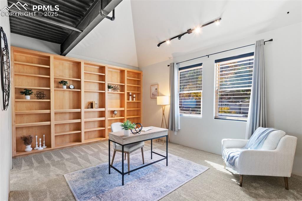 Second primary bedroom with adjoining bathroom and built-in shelving