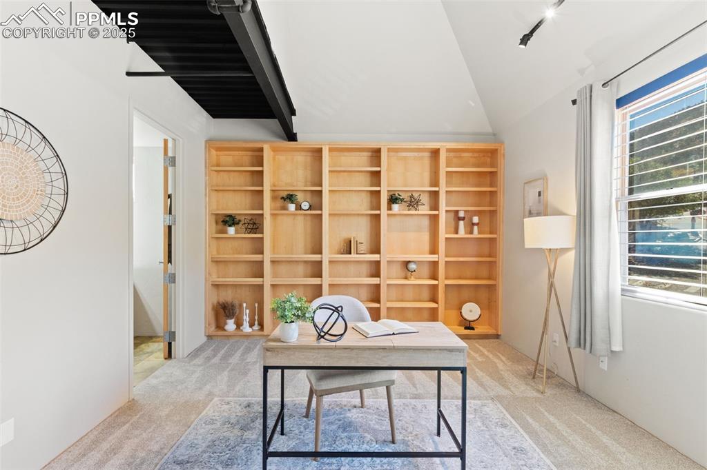 Second primary bedroom with adjoining bathroom and built-in shelving
