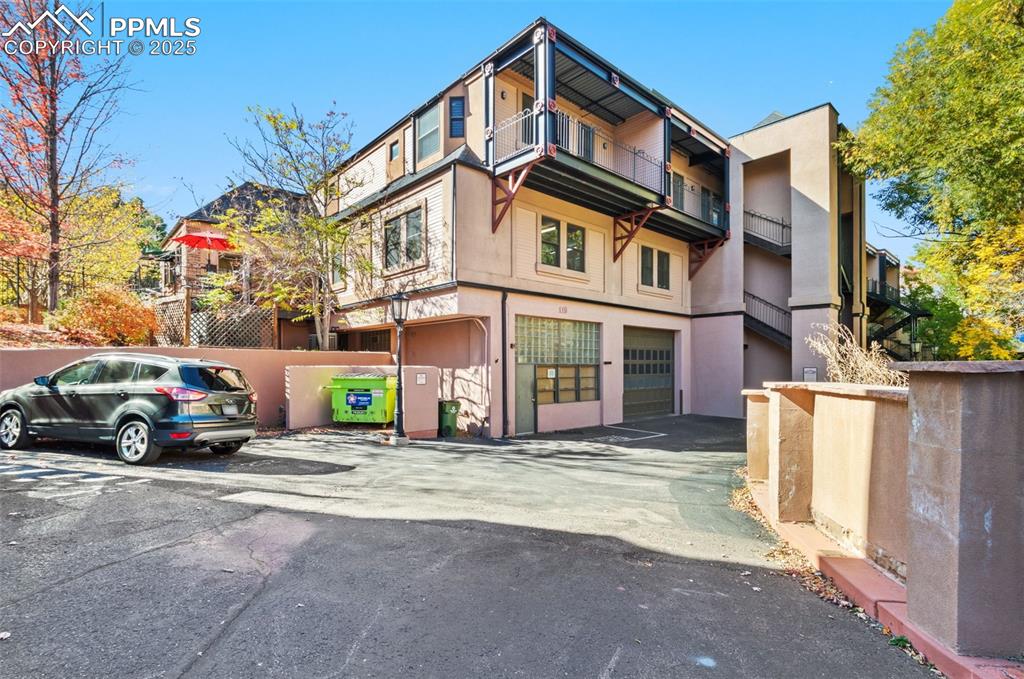 View of property featuring an attached garage and large storage area