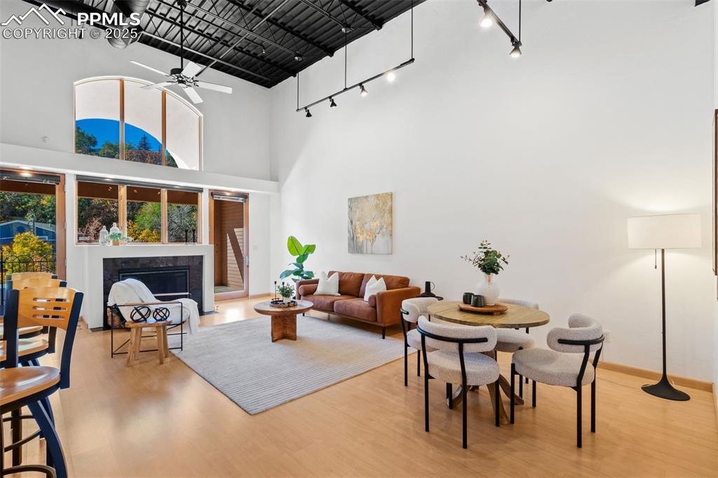 Open floor plan featuring the living room, dining room, and natural light through the large windows