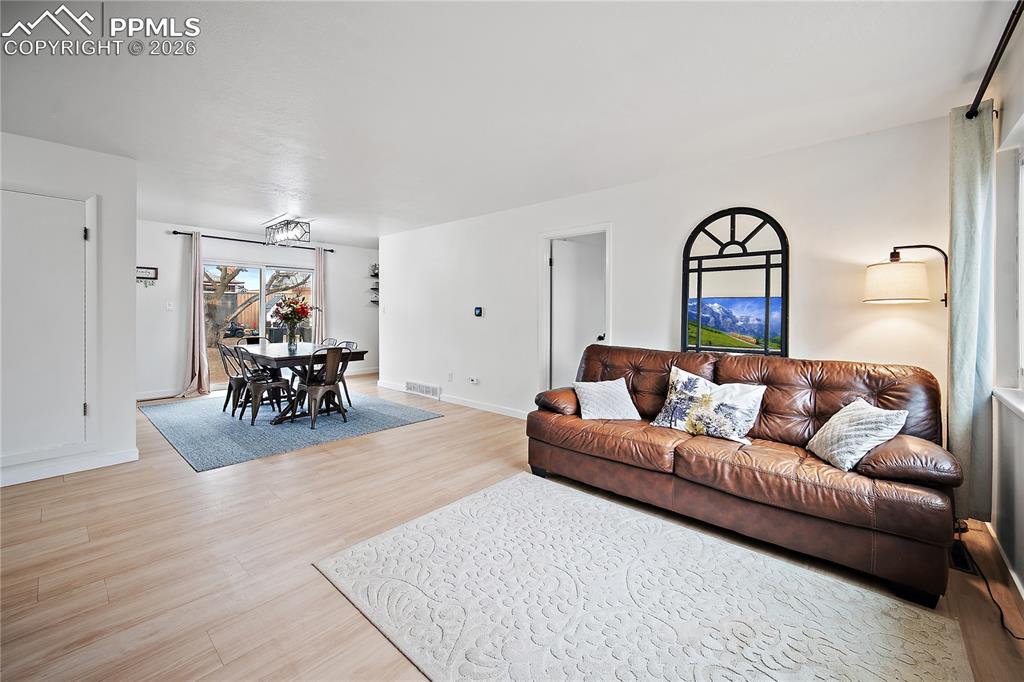Living room with laminate flooring. Open to the dining room. 